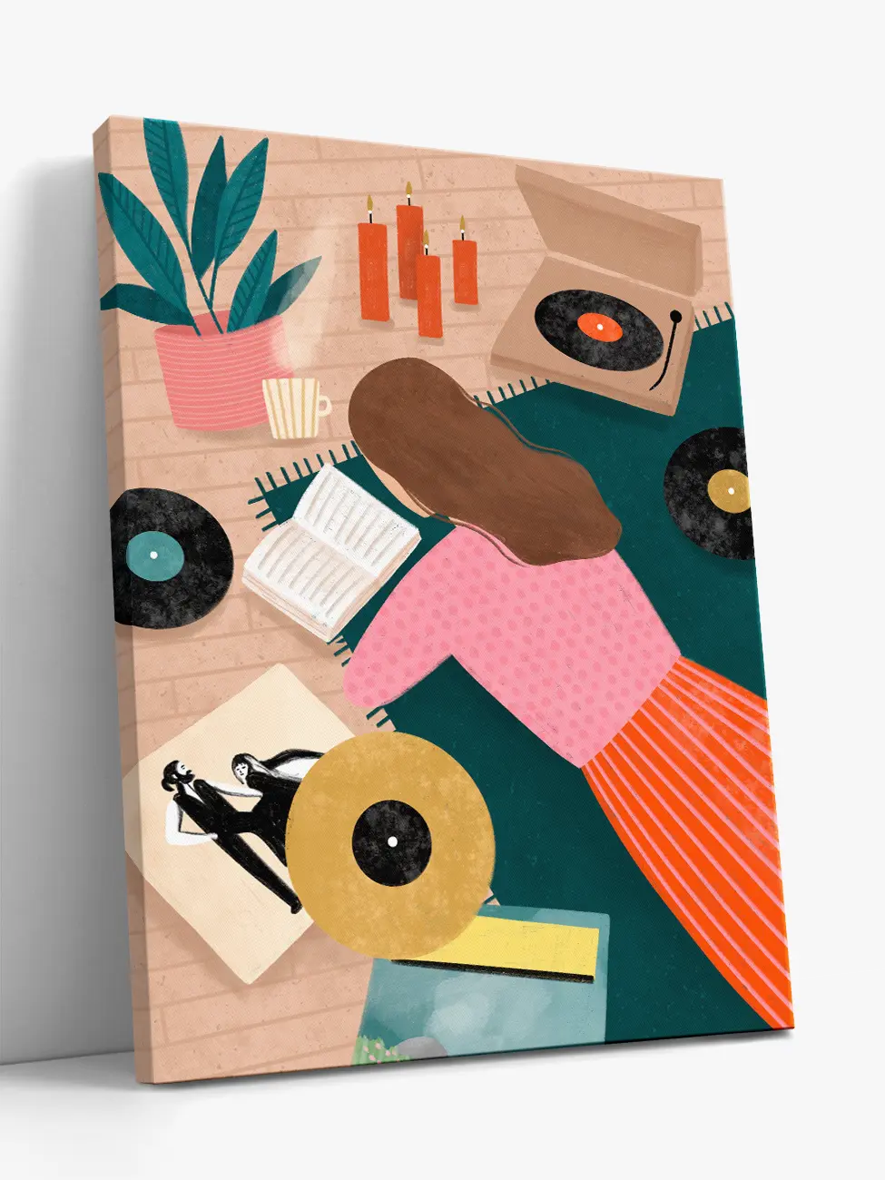 A rectangular canvas art print shown at an angle against a light gray background. The artwork features a retro-style illustration of a woman with brown hair, wearing a pink top and orange striped skirt, surrounded by vinyl records, a turntable, candles, a plant, and an open book on a teal and beige background.