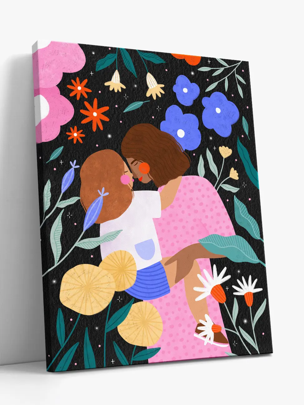 A rectangular canvas print featuring a stylized illustration of a woman holding a child, surrounded by colorful flowers and leaves on a black background, shown at an angle against a light gray wall.
