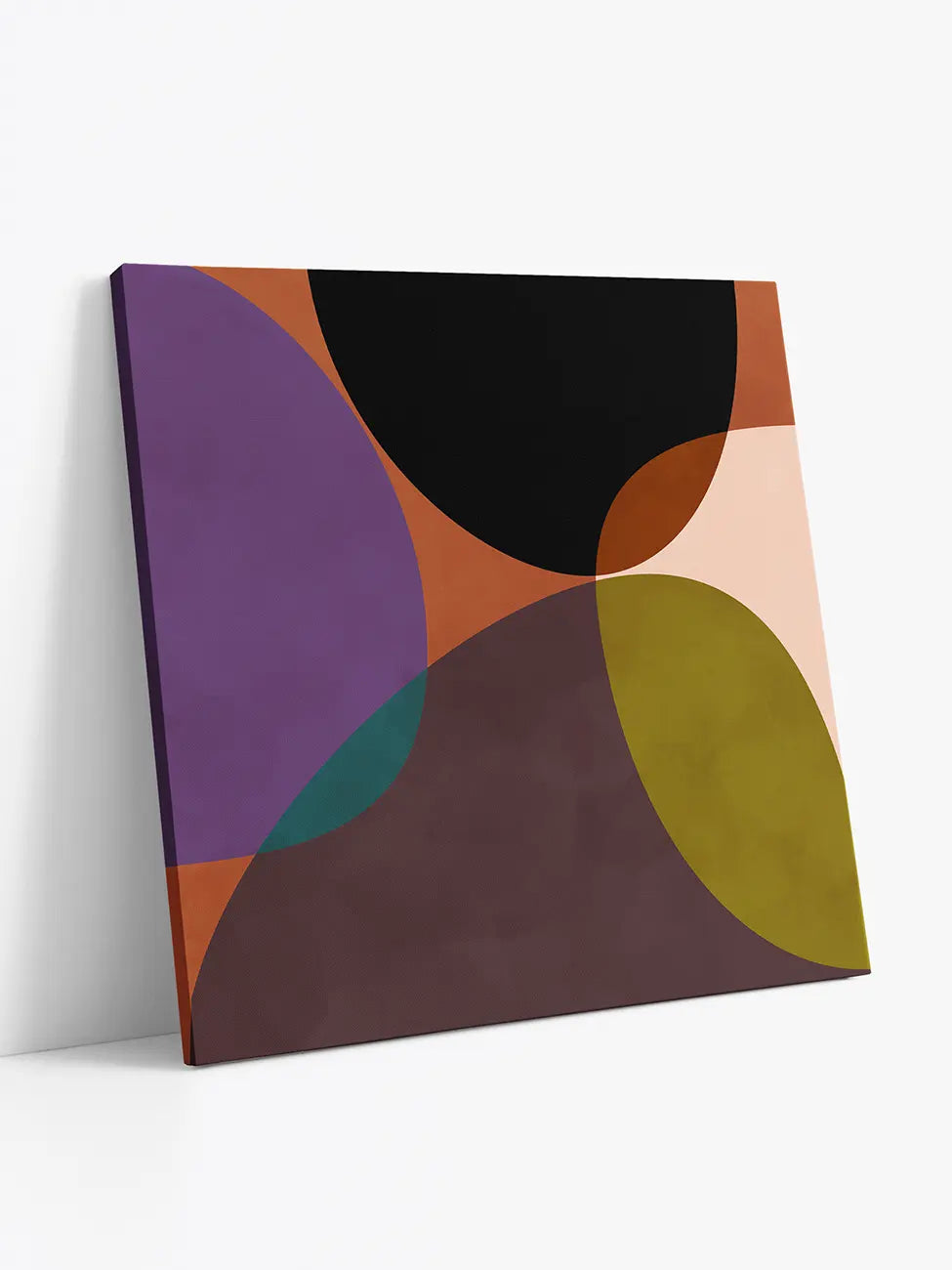 Terracotta Circles canvas print standing against a white wall, showing the side edges and depth of the canvas