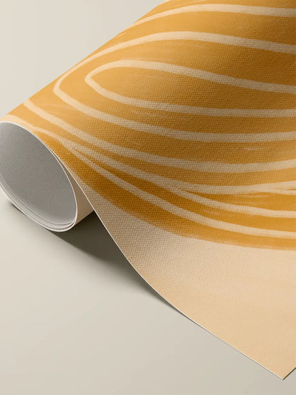Rolled cotton canvas print: an ochre field with pale curving stripes, on a  sand background.